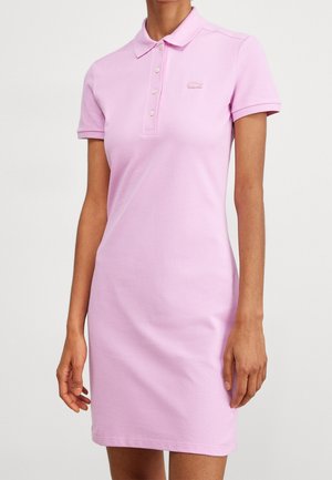 Fitted short-sleeve pink polo dress with collar and buttons, featuring a small embroidered logo on the chest.