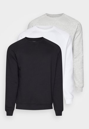 Three crewneck sweatshirts in black, white, and light gray. They feature long sleeves, ribbed cuffs, and soft, textured fabric.
