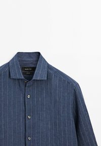 Blue long-sleeve button-up shirt with white vertical pinstripes and a pointed collar, labeled Massimo Dutti.