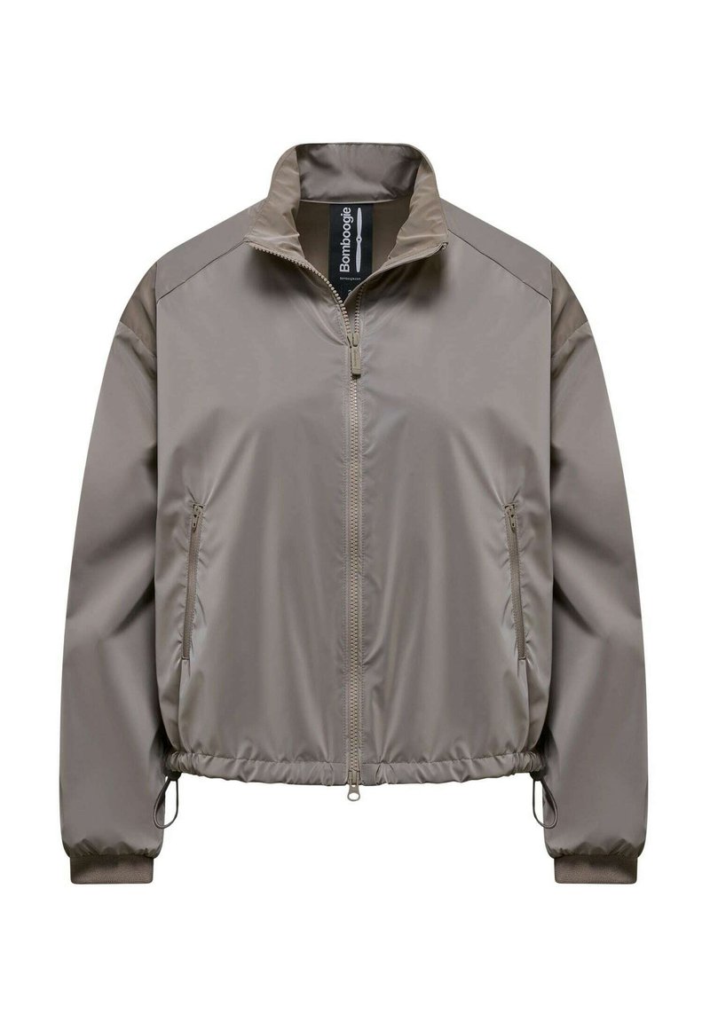 Veste coupe-vent marron clair zippée avec col montant, poignets élastiques et poches latérales zippées.