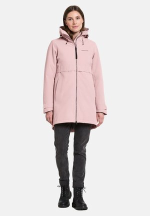 Long pink waterproof parka with a hood, front zipper, and drawstring detail. Features a relaxed fit and is paired with dark gray pants and black boots.