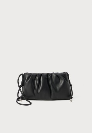 Black leather crossbody bag with gathered design, adjustable strap, and subtle logo. Smooth texture and streamlined rectangular shape.