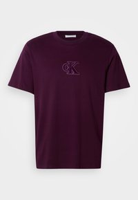 Dark purple cotton t-shirt with a round neck and short sleeves, featuring an embroidered "ck" logo on the chest. Smooth texture.