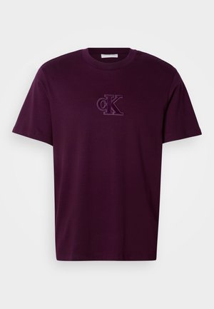 Dark purple cotton t-shirt with a round neck and short sleeves, featuring an embroidered "ck" logo on the chest. Smooth texture.