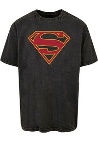 Black cotton t-shirt with a distressed finish featuring a yellow and red Superman logo in the center, short sleeves, and a classic crew neck.