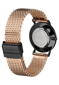 Roze gouden mesh horlogeband met een zwarte metalen kast. Heeft een gladde, glanzende oppervlakte en een verstelbare sluiting. De achterkant toont het merk en specificaties.