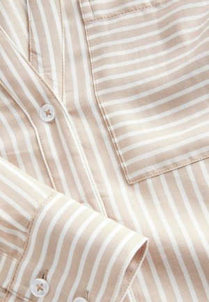 Beige and white striped shirt with button closures, a chest pocket, and smooth fabric texture. Cuffs feature matching striped pattern.