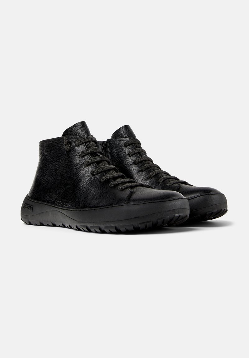 Black leather high-top sneakers with textured finish, round toe, lace-up design, and rubber outsole featuring a rugged tread pattern.