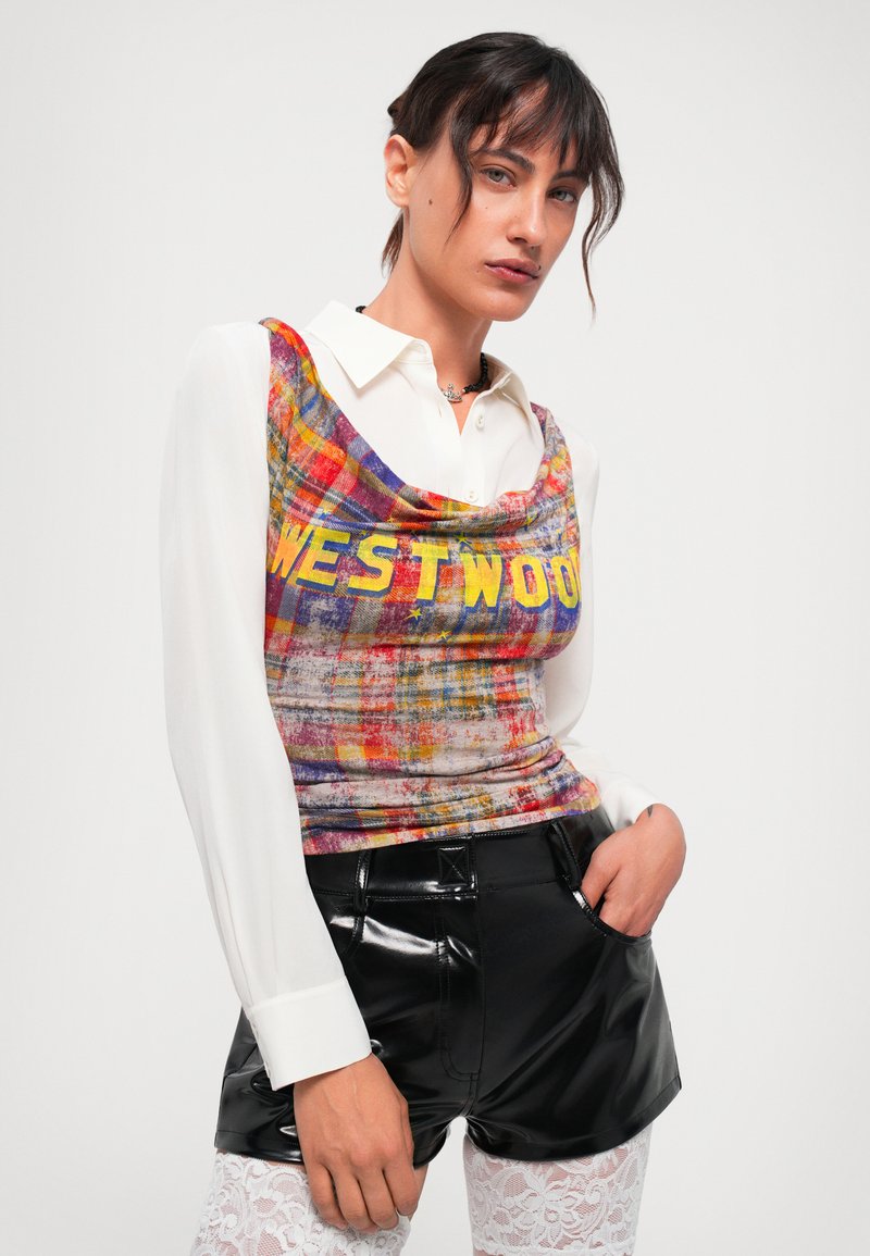 Multi-colored plaid top with "WESTWOOD" text, paired with a white long-sleeve shirt and glossy black shorts. Textured fabric with draping.