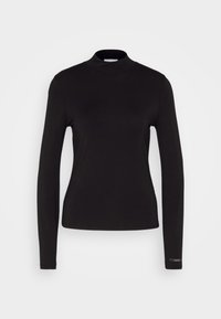 Schwarzes Langarm-Turtleneck-Oberteil aus glattem Stoff. Figurbetonter Schnitt mit hohem Kragen und subtiler Logoakzent auf dem Ärmel.