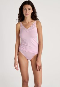 Light pink camisole with lace trim along the neckline and matching lace brief. Soft fabric with a fitted shape.