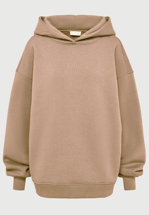 Haut à capuche oversized couleur tan en mélange de coton doux, avec un cordon de serrage à la capuche, des poignets côtelés et un logo brodé à l'avant. Texture lisse.