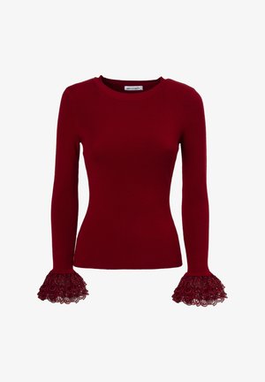 Roter gerippter Langarmpullover mit Spitzenlatzhülsen, die über kreisförmige Muster verfügen. Rundhalsausschnitt und taillierte Silhouette.