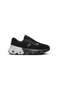 Black athletic shoe with a textured upper, contrasting white midsole, and unique hollowed-out sole design; features a sleek, modern shape.
