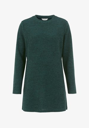 Teal pitkähihaisen tunika, joka on valmistettu teksturoidusta kankaasta. Siinä on pyöreä pääntie ja suora leikkaus. Helma on takaa hieman pidempi.