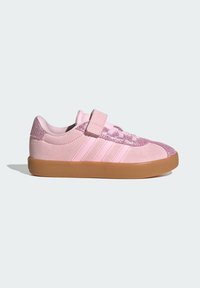 Pink sneakers with a suede texture, glittery accents on the toe, a velcro strap, and a gum rubber sole. Three white stripes on the side.