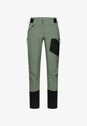 Green outdoor pants with a black pocket, two front zippers, and a reinforced bottom. Made from durable, breathable fabric.