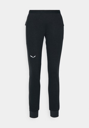 Pantaloni de trening negri, cu o croială slim, având un tiv elastic la talie, manșete strâmte și un mic logo alb pe coapsa stângă.