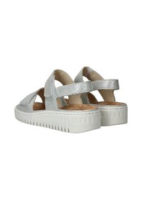 Grijze geweven sandalen met verstelbare klittenbandriempjes en een gestructureerde kurken voetbed, met een witte rubberen zool met verticale ribbels.