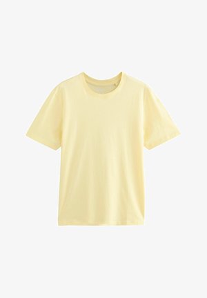 Lühikeste varrukatega, ümmarguse kaelusega t-särk heledas kollases. Valmistatud pehmest puuvillast, millel on sile tekstuur ja mugav lõige. Ilma graafiliste detailideta.