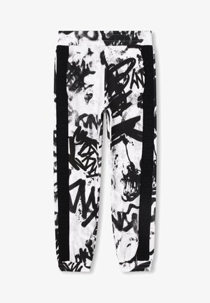 Spodnie dresowe o wzorze w stylu graffiti czarno-białym, z czarnymi bocznymi paskami i elastycznymi mankietami.