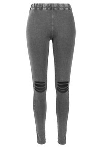 Sivé legíny slim-fit s elastickým pásom a horizontálnymi čiernymi výrezmi nad kolenami na oboch nohách.