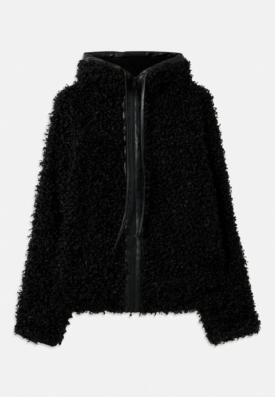 Juodas gobtuvas striukė, pagaminta iš pūkuoto, tekstūruoto audinio, su užtrauktuku ir odiniais akcentais aplink apykaklę ir priekyje.