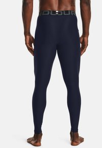 Marine compressiekousen met een brede tailleband met de tekst "HOLD". Glad, rekbaar materiaal, getailleerd ontwerp en enkel-lange snit.