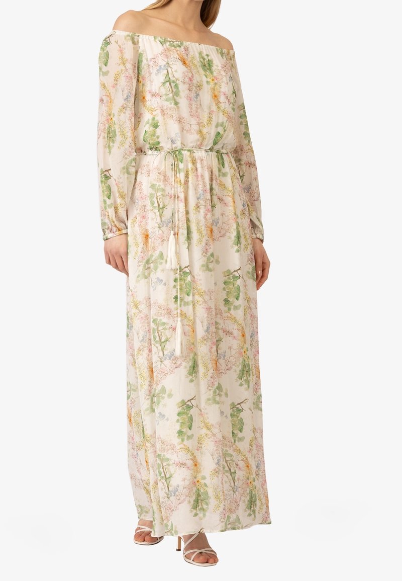 Robe maxi florale avec décolleté en cheveux, manches longues, taille cintrée et tissu doux et léger présentant des motifs floraux pastel.