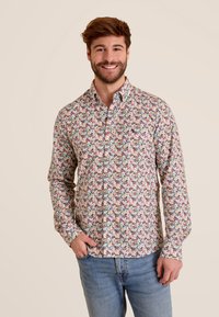 Langsleeve, knoop-overhemd van katoen met een multicolore bloemenpatroon op een lichte achtergrond. Voorzien van een kraag en een enkele borstzak.