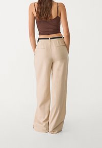 Beige linnen wijde broek met een gladde textuur, voorzien van een taps toelopende taille, twee achterzakken en een zwart geweven riemdetail.