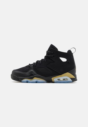 Black athletic shoe with suede upper, mesh accents, gold and blue details, and a visible air cushioning unit in the heel.