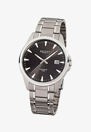 Silver metal wristwatch with black dial, white triangular hour markers, date display at 3 o’clock, and three silver hands showing 10:11:38.