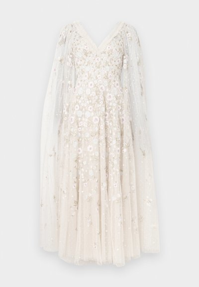 Midi šaty v slonovinovej farbe s výstrihom do V, zdobené kvetinovou výšivkou a priesvitnými dlhými rukávmi. Materiál je mäkký so vzorom bodiek.