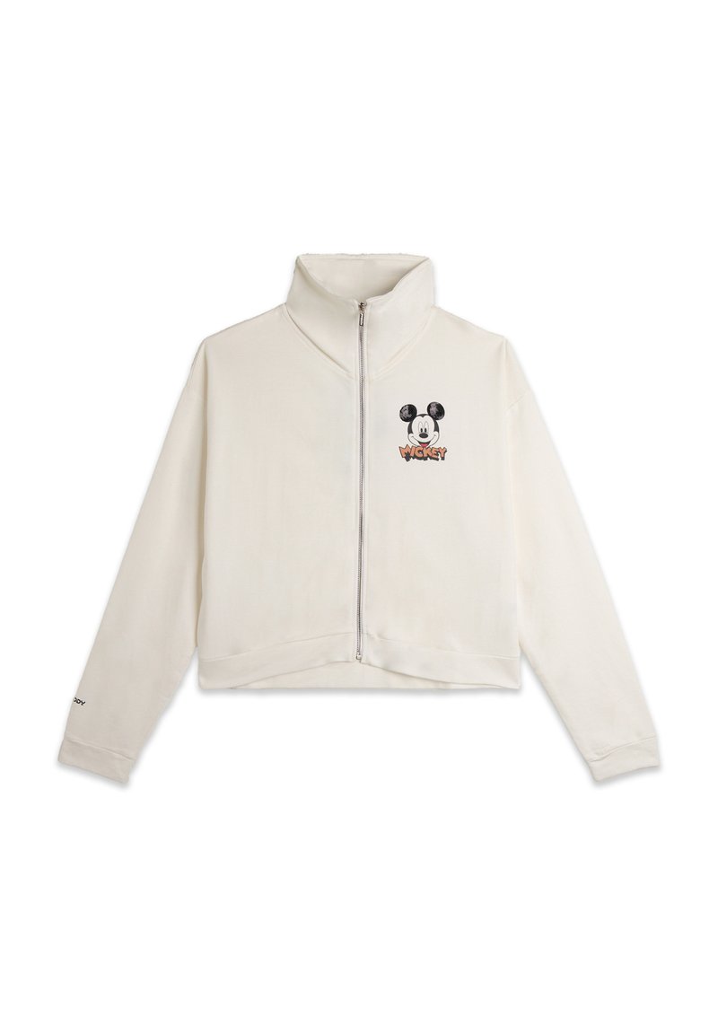 Sweatshirt zippé court crème avec col montant, orné d'un graphique noir de Mickey Mouse et du texte "WICKY" en orange. Tissu doux, coupe décontractée.