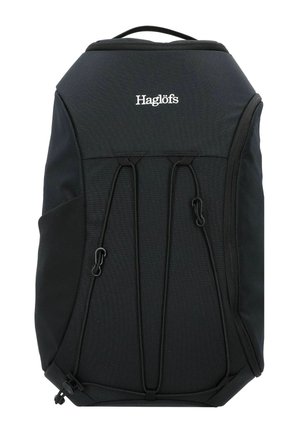 Zaino Haglöfs nero con maniglia superiore, attacchi con corda elastica nella parte anteriore e tasca con zip laterale, progettato per l'uso all'aperto.