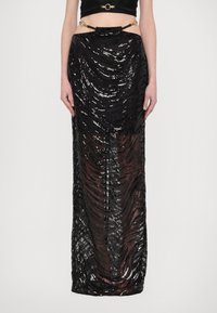 Black sequined skirt with a wavy texture, floor-length, sheer sections, and a decorative waistband featuring gold accents.