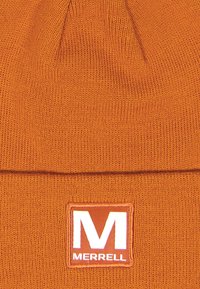 Orange knit beanie featuring a fold-over cuff and a square Merrell logo patch in white and orange on the front. Textured fabric finish.