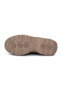Tan rubber shoe sole with deep treads, featuring the word "WODEN" embossed prominently and a durable, textured finish.
