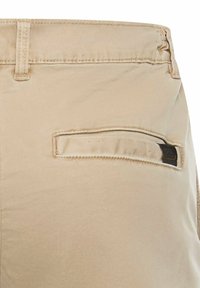 Khakifarbene Baumwollshorts mit einer Gesäßtasche, die eine horizontale Öffnung, verstärkte Nähte und ein kleines Markenlogo-Patch an der Tasche aufweist.