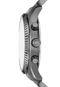 Men's watch with a textured grey metal case, ridged bezel, and two side pushers. Features a clean white dial and engraved MK logo on crown.