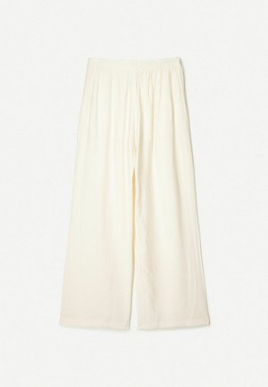 Crème wijde broek met een elastische tailleband, gemaakt van een lichte, gestructureerde stof. Heeft een ontspannen pasvorm en geen zichtbare patronen.