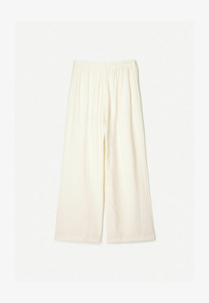 Kremowe spodnie o szerokich nogawkach z elastycznym pasem, wykonane z lekkiego, teksturowanego materiału. Charakteryzują się luźnym krojem i brakiem widocznych wzorów.