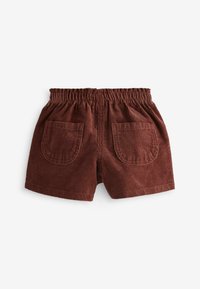 Braune Cordshorts mit einem elastischen Bund und zwei Gesäßtaschen. Der Stoff hat eine gerippte Textur.