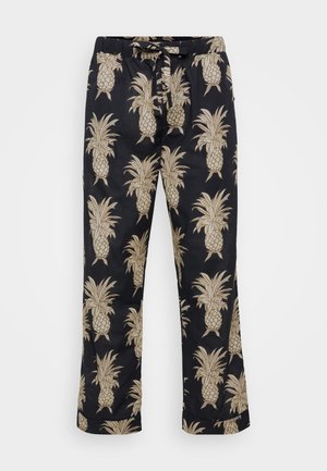 Calças de corte solto em tecido preto com um padrão de abacaxis dourados repetidos. Cintura elástica com cordão; textura suave.