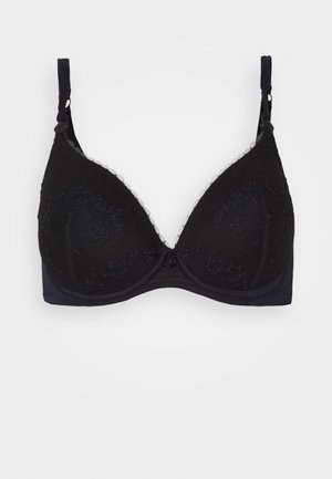 Reggiseno nero con pizzi, dotato di coppe triangolari e caratterizzato da intricate ricami floreali sulle coppe e spalline regolabili. Fodera in tessuto morbido.