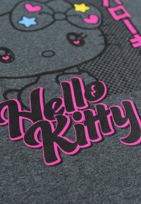 Gray fabric features a printed Hello Kitty design with a pink bow, stars in blue and yellow, and bold pink text reading "Hello Kitty."