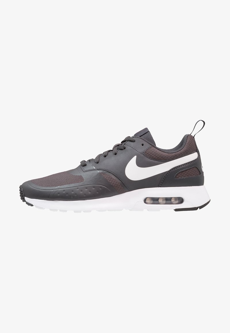 Nike Air Max shoes, featuring a black upper with textured accents, white sole, prominent Swoosh logo, and visible air cushioning unit.