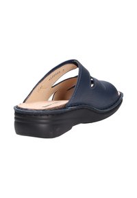 Navy leather sandal with open toe and side cutouts, featuring a cushioned insole and low black heel. Stitching detail along the edges.