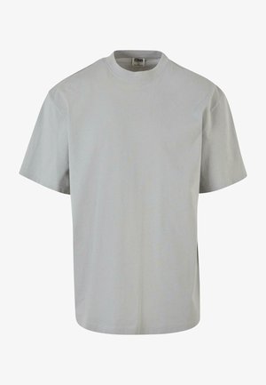 Lys grå bomulds t-shirt med rund hals, korte ærmer, lige skæring, sideslids og minimale synlige detaljer.